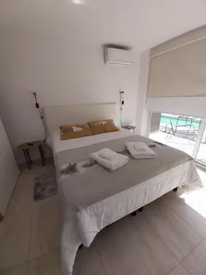 a bedroom with a bed with two towels on it at Prado del Lago in Villa Rumipal