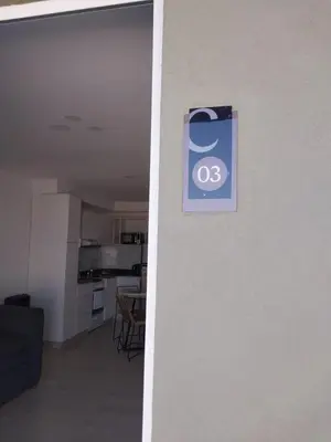 a sign on the side of a wall next to a kitchen at Prado del Lago in Villa Rumipal