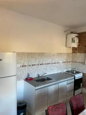 a kitchen with a sink and a refrigerator at La lomita de Nono in Arroyo de Los Patos