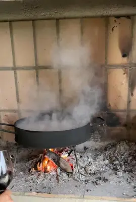 a pot on top of a fire with smoke at Casareartesesok in Los Reartes