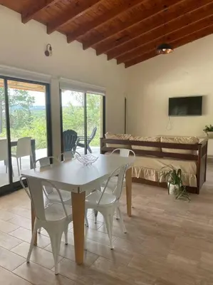 a dining room with a table and chairs and a couch at Casareartesesok in Los Reartes