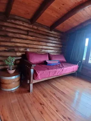 a bed in a room with a wooden floor at La Casa de Conco in La Estancia
