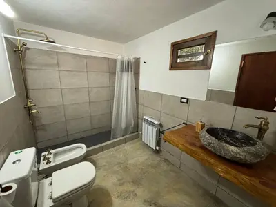 a bathroom with a toilet and a sink at La Casa de Conco in La Estancia