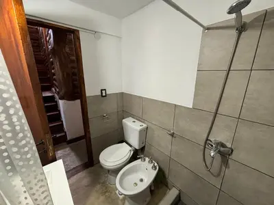 a bathroom with a toilet and a sink at La Casa de Conco in La Estancia