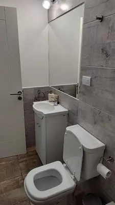 a bathroom with a white toilet and a sink at Agradable departamento en Alta Córdoba in Cordoba