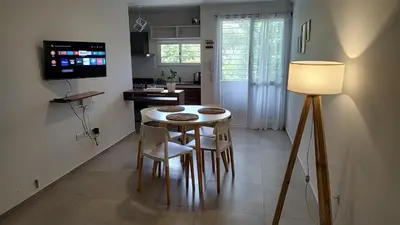 a kitchen with a table and chairs in a room at Agradable departamento en Alta Córdoba in Cordoba