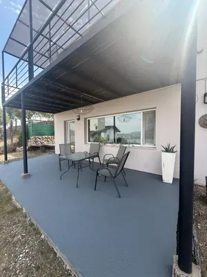 a patio with chairs and a table on it at Departamento Paris in Villa Carlos Paz