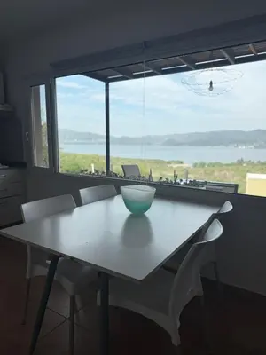 a table with a bowl on it in front of a window at Departamento Paris in Villa Carlos Paz