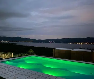 a swimming pool with a view of the water at Departamento Paris in Villa Carlos Paz