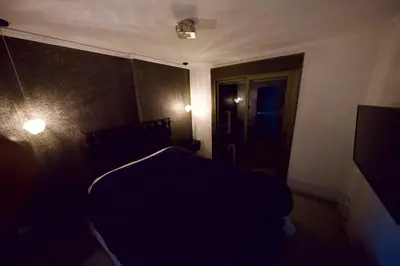 a bedroom with a bed in a dark room at Perfect location Apartment in Nva Cba in Cordoba