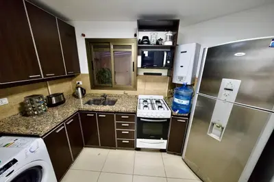 a small kitchen with a refrigerator and a stove at Perfect location Apartment in Nva Cba in Cordoba