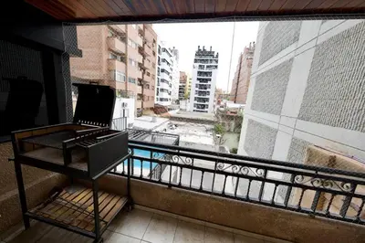 a laptop on a table on a balcony with a window at Perfect location Apartment in Nva Cba in Cordoba