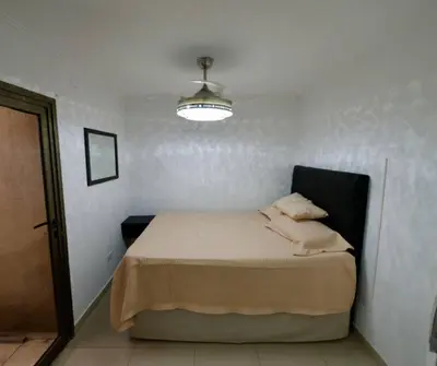 a bedroom with a bed in a room with a light at Perfect location Apartment in Nva Cba in Cordoba