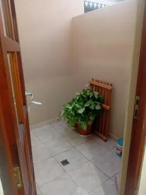 a bathroom with a plant in the corner of a room at Departamento calido, cerc in Río Tercero
