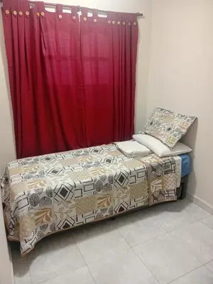 a bed in a room with a red curtain at Departamento calido, cerc in Río Tercero