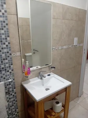 a bathroom with a sink and a mirror at Departamento calido, cerc in Río Tercero