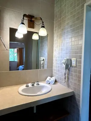 a bathroom with a sink and a mirror at Kentitaku cabañas de montaña in Las Rabonas