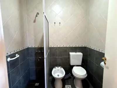 a small bathroom with a toilet and a shower at Kentitaku cabañas de montaña in Las Rabonas
