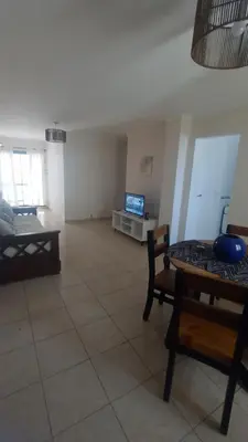 a living room with a tv and a couch and a table at Precioso y Muy Cómodo Departamento en Excelente Zona Centrica in Cordoba