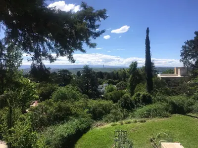 a view of a garden with trees and bushes at Balcones de Costa Azul in Villa Carlos Paz