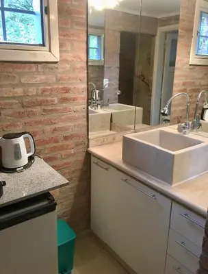 a bathroom with a sink and a mirror at Balcones de Costa Azul in Villa Carlos Paz