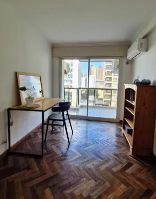 a room with a table and a chair and a large window at Bravo 6 - Luminoso y amplio depto cerca de todo! in Cordoba