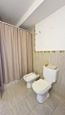 a bathroom with a toilet and a bidet at Bravo 6 - Luminoso y amplio depto cerca de todo! in Cordoba