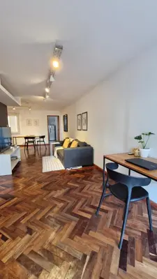 a living room with a couch and a table at Bravo 6 - Luminoso y amplio depto cerca de todo! in Cordoba