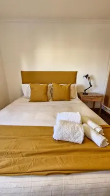 a bedroom with a large bed with two towels on it at Bravo 6 - Luminoso y amplio depto cerca de todo! in Cordoba
