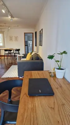 a living room with a table with a laptop on it at Bravo 6 - Luminoso y amplio depto cerca de todo! in Cordoba