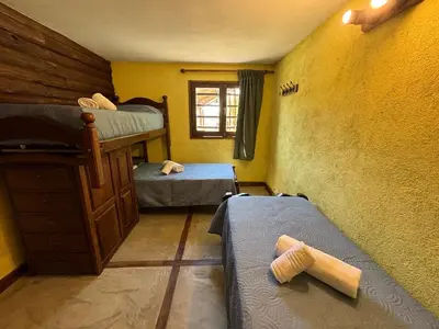a room with two bunk beds and a window at La Casa de Conco in La Estancia