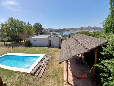 a backyard with a swimming pool and an umbrella at La Casa de Conco in La Estancia