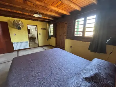 a bedroom with a large bed in a room at La Casa de Conco in La Estancia