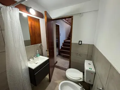 a bathroom with a toilet and a sink and a shower at La Casa de Conco in La Estancia