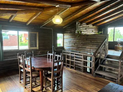 a dining room with a wooden table and chairs at La Casa de Conco in La Estancia