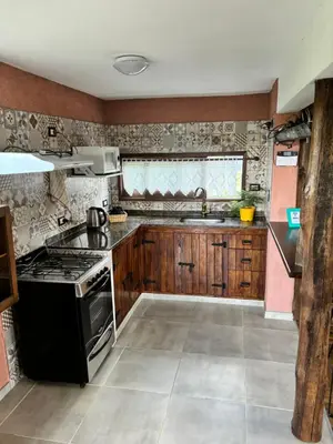 a kitchen with a stove and a sink at La Casa de Conco in La Estancia