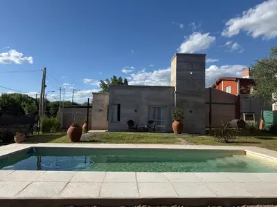 a small swimming pool in front of a house at SuiteMilSueños in Mina Clavero