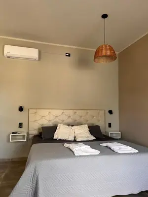 a bedroom with a large bed with two towels on it at SuiteMilSueños in Mina Clavero