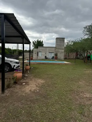 a house with a car parked in front of it at SuiteMilSueños in Mina Clavero