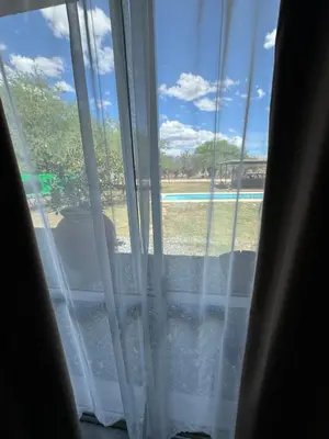 a window with a view of a pool at SuiteMilSueños in Mina Clavero