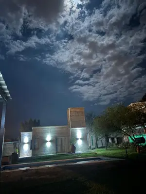 a building with lights on the side of it at night at SuiteMilSueños in Mina Clavero