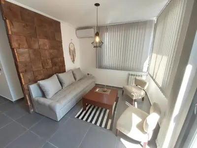 a living room with a couch and a table at Dpto 1 Dormitorio de categoria in Villa Carlos Paz