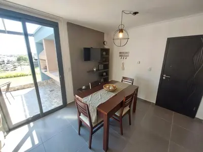 a dining room with a table and chairs and a window at Dpto 1 Dormitorio de categoria in Villa Carlos Paz