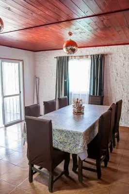 a dining room with a table and chairs at Potrero de Garay Los Espinillos in Potrero de Garay