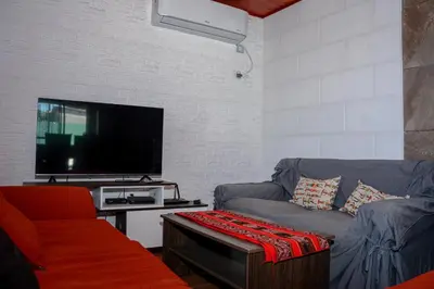a living room with a couch and a flat screen tv at Potrero de Garay Los Espinillos in Potrero de Garay
