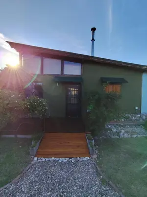 a house with a wooden deck in front of it at Loft Campestre - Los Reartes in Los Reartes