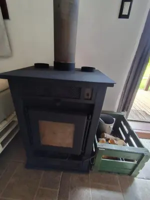 a black stove in a room with some food inside at Loft Campestre - Los Reartes in Los Reartes