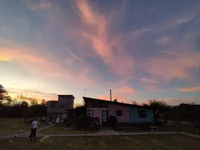 a person standing in front of a house with a kite at Loft Campestre - Los Reartes in Los Reartes
