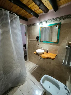a bathroom with a shower and a sink and a mirror at Loft Campestre - Los Reartes in Los Reartes