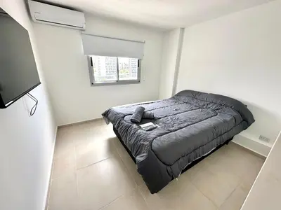 a bedroom with a bed in a white room at Alojamiento entero para 4 personas F in Cordoba